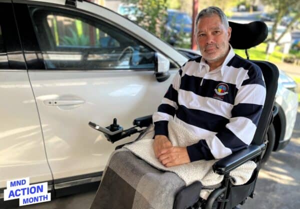 Mike Brown at home beside his modified Mazda CX-9 — a vehicle that helped him stay mobile and independent after his MND diagnosis.